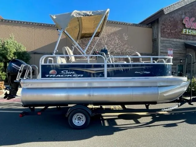 The Image of 2025 Sun Tracker Bass Buggy 16 XL Select pontoon boat on trailer. - 0