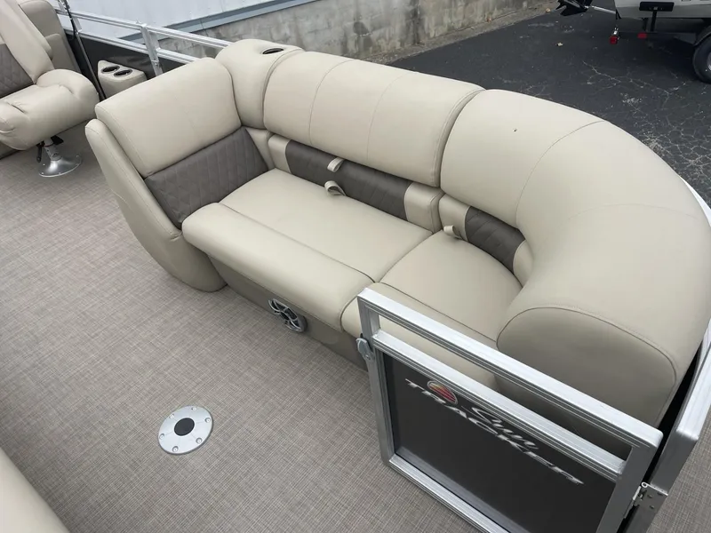 Slide: The Image of 2025 Sun Tracker Party Barge 22 DLX interior with beige seating and carpeted flooring. - 8