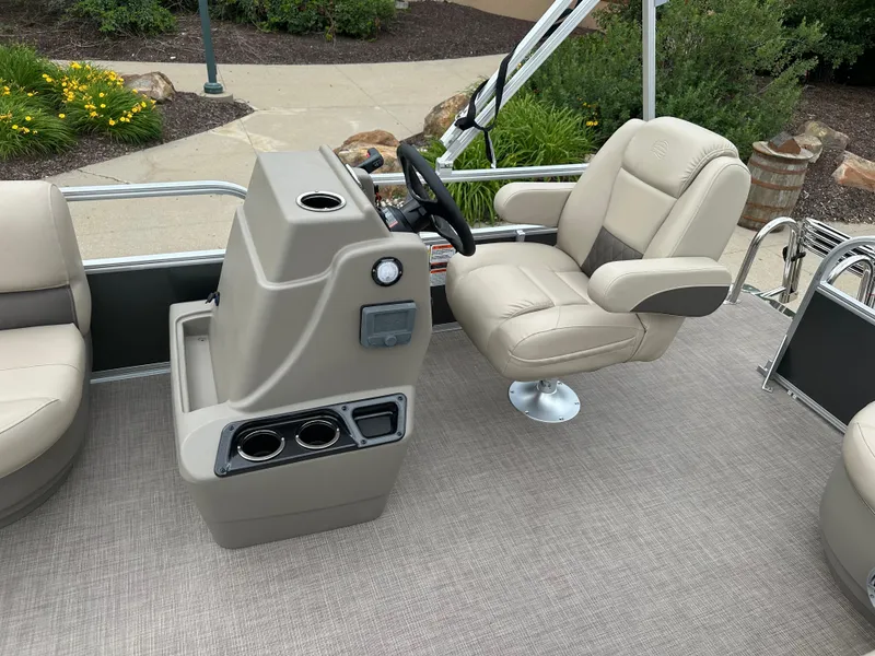 Slide: The Image of 2025 Sun Tracker Party Barge 16 DLX interior with captain's chair and console. - 6