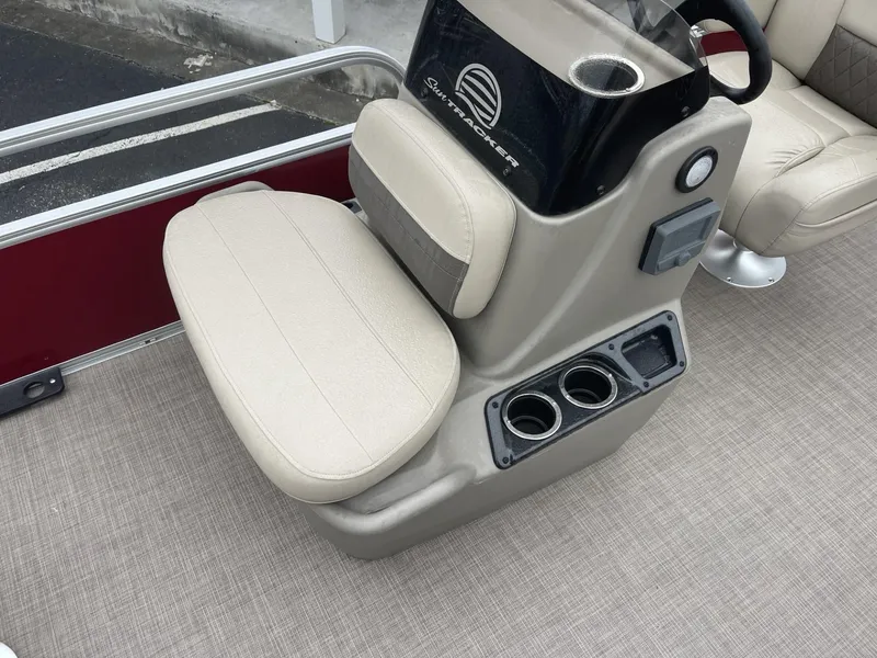 Slide: The Image of 2025 Sun Tracker Bass Buggy 16 XL Select boat seat with cup holders and steering console. - 12