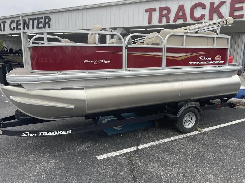 Slide: The Image of 2025 Sun Tracker Bass Buggy 16 XL Select pontoon boat on trailer. - 3