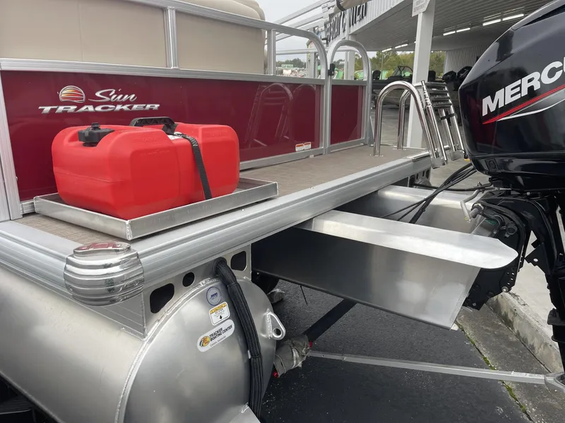 Slide: The Image of 2025 Sun Tracker Bass Buggy 16 XL Select pontoon boat with red fuel tank and Mercury engine. - 5