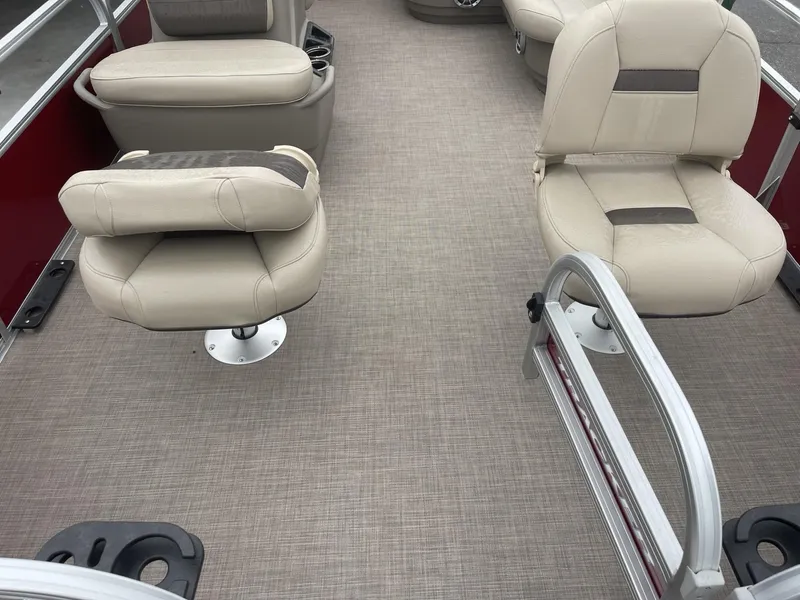 Slide: The Image of 2025 Sun Tracker Bass Buggy 16 XL Select interior with beige seating and carpeted flooring. - 6