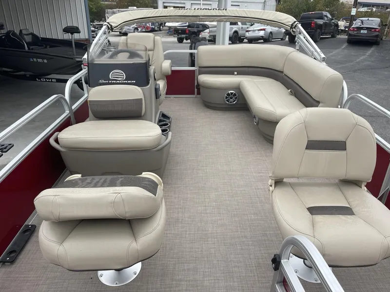 Slide: The Image of 2025 Sun Tracker Bass Buggy 16 XL Select pontoon boat interior with beige seating. - 7