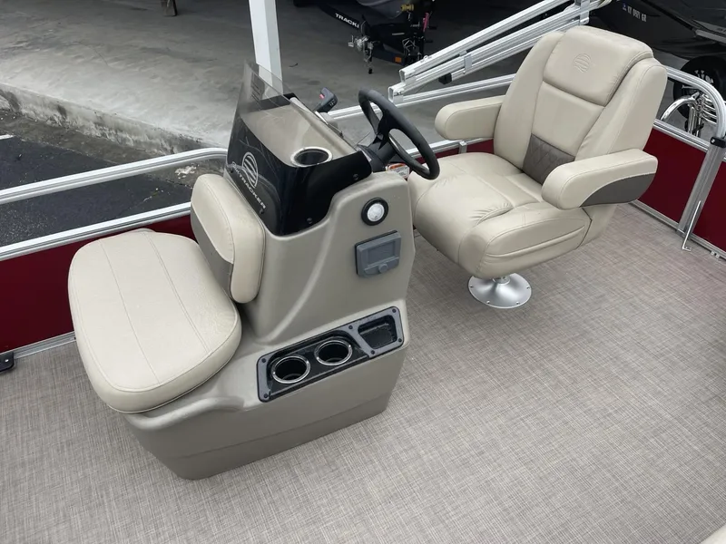 Slide: The Image of 2025 Sun Tracker Bass Buggy 16 XL Select boat interior with beige seating and steering console. - 9