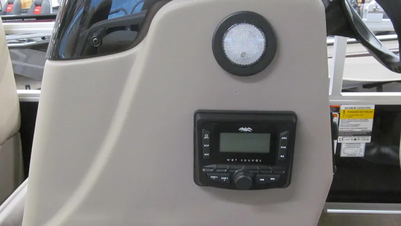 Slide: The Image of 2025 Sun Tracker Party Barge 16 DLX dashboard with audio controls and speaker. - 10