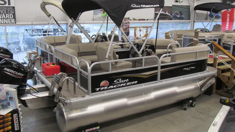 Slide: The Image of 2025 Sun Tracker Party Barge 16 DLX pontoon boat in showroom. - 3