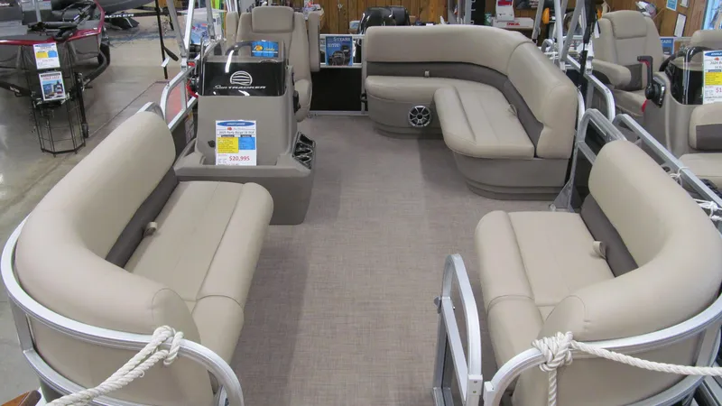 Slide: The Image of 2025 Sun Tracker Party Barge 16 DLX interior with beige seating and spacious layout. - 4