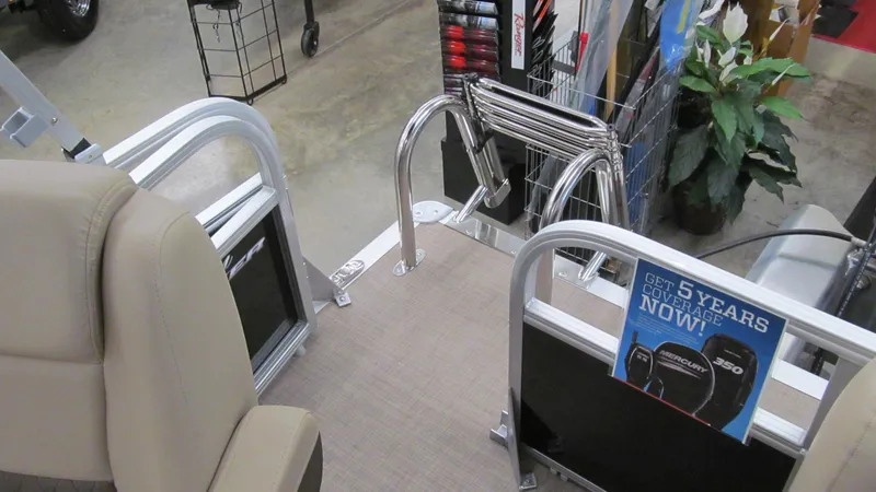 Slide: The Image of 2025 Sun Tracker Party Barge 16 DLX interior with seating and promotional display. - 7