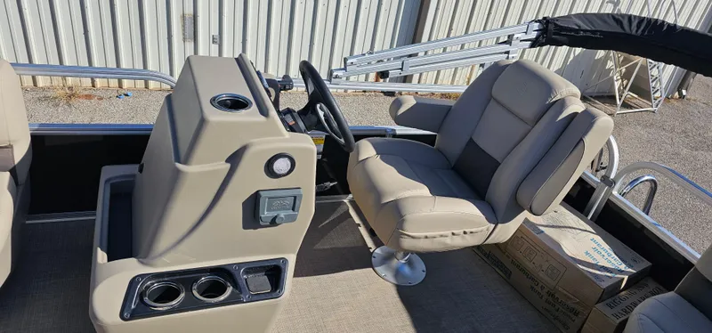 Slide: The Image of 2025 Sun Tracker Party Barge 16 DLX interior with steering console and seating. - 12