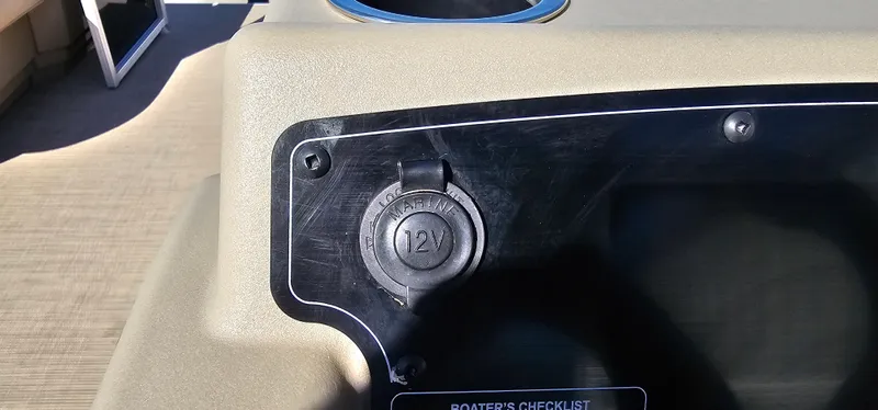 Slide: The Image of 12V outlet on 2025 Sun Tracker Party Barge 16 DLX boat dashboard. - 18
