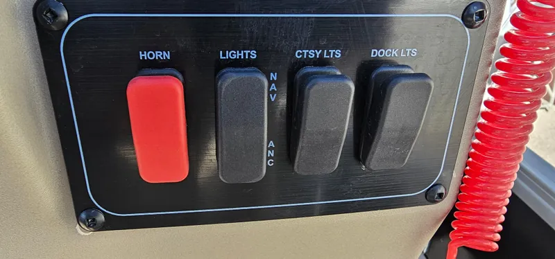 Slide: The Image of Control panel of 2025 Sun Tracker Party Barge 16 DLX with horn and light switches. - 20