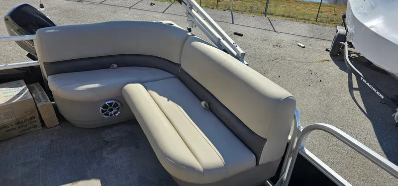 Slide: The Image of 2025 Sun Tracker Party Barge 16 DLX with beige seating and speaker system. - 21