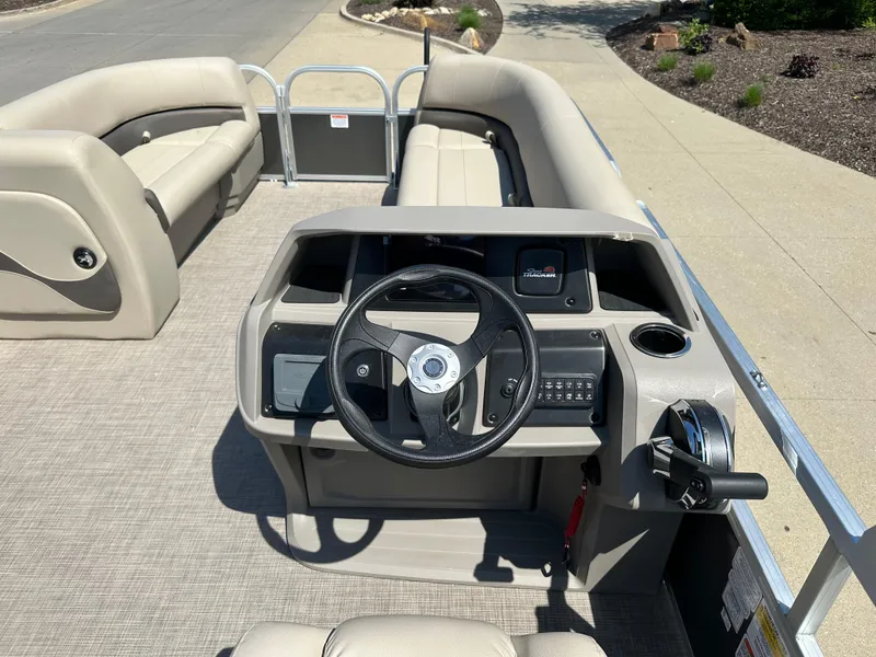 Slide: The Image of 2025 Sun Tracker Party Barge 18 DLX interior with steering console and seating. - 4