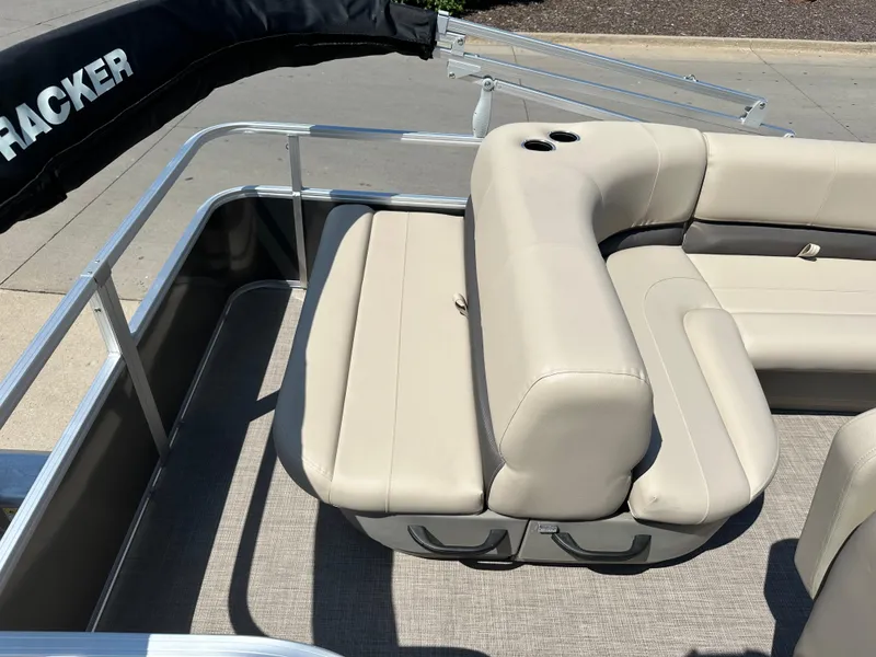 Slide: The Image of 2025 Sun Tracker Party Barge 18 DLX with beige seating and cup holders. - 6