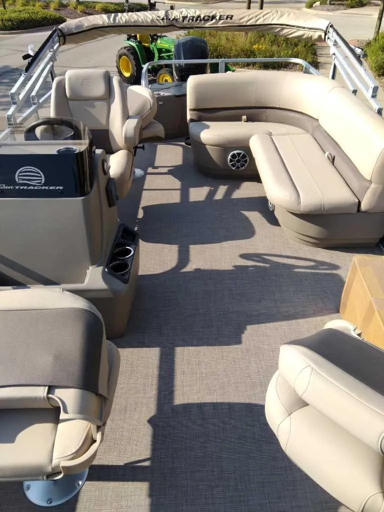 Slide: The Image of 2025 Sun Tracker Bass Buggy 18 DLX pontoon boat interior with beige seating. - 3