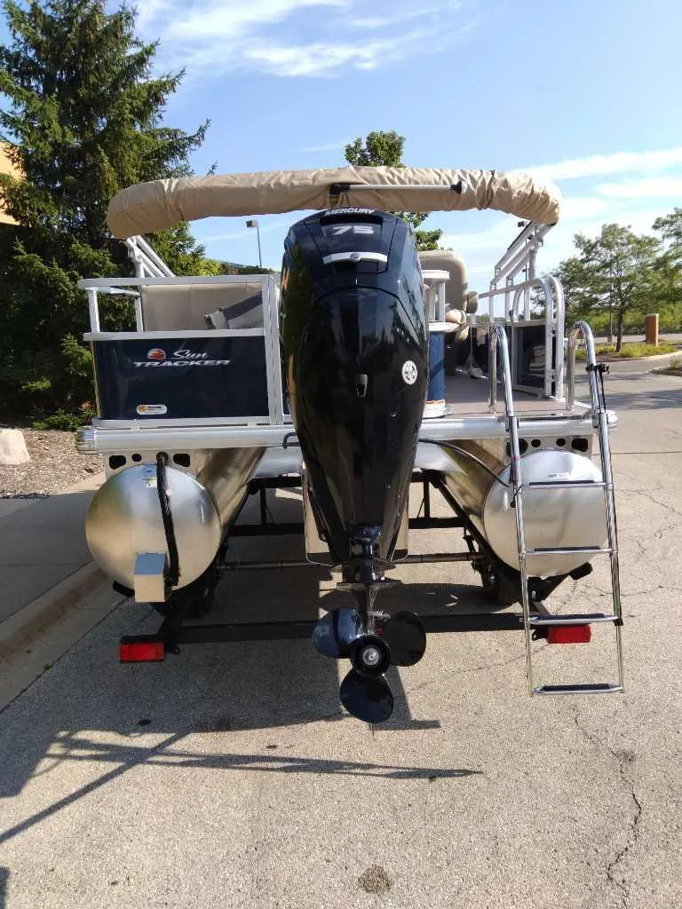 Slide: The Image of 2025 Sun Tracker Bass Buggy 18 DLX pontoon boat with outboard motor. - 4