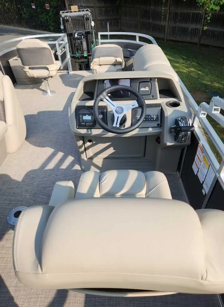 Slide: The Image of 2025 Sun Tracker Fishin' Barge 20 DLX interior with steering console and seating. - 4