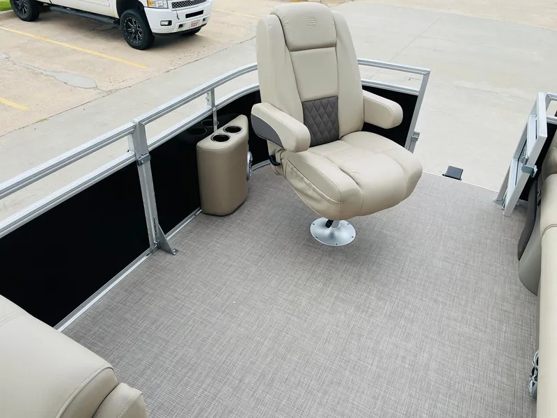 Slide: The Image of 2025 Sun Tracker SportFish 20 DLX boat interior with beige captain's chair and carpeted deck. - 10