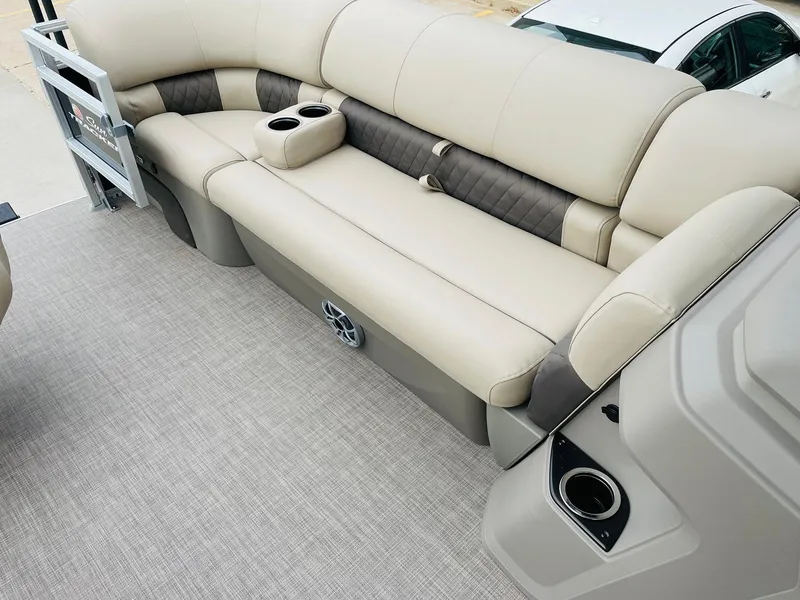 Slide: The Image of 2025 Sun Tracker SportFish 20 DLX boat interior with beige seating and cup holders. - 11