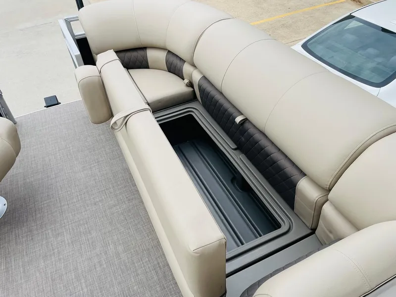 Slide: The Image of 2025 Sun Tracker SportFish 20 DLX boat interior with beige seating and storage compartment. - 13