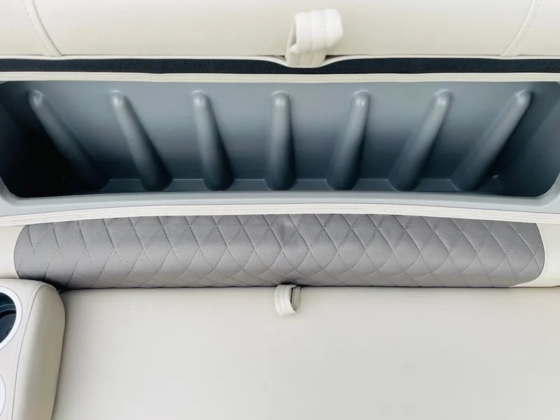 Slide: The Image of 2025 Sun Tracker SportFish 20 DLX boat storage compartment with quilted upholstery. - 16