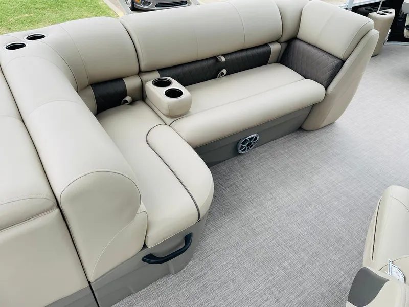 Slide: The Image of 2025 Sun Tracker SportFish 20 DLX interior with beige seating and cup holders. - 17