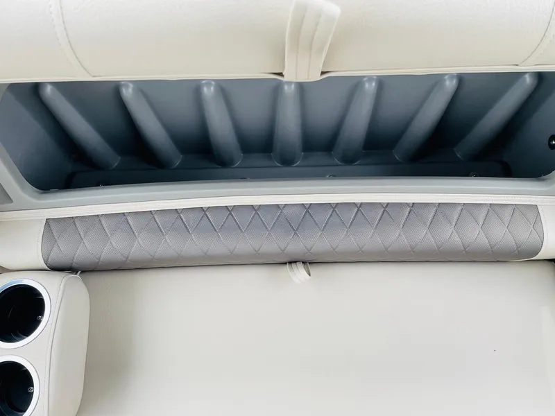 Slide: The Image of 2025 Sun Tracker SportFish 20 DLX boat interior with storage compartment and cup holders. - 19