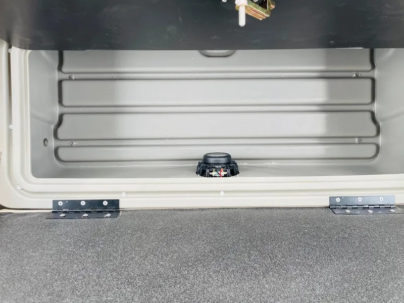 Slide: The Image of Sun Tracker SportFish 20 DLX 2025 storage compartment with secure latch and durable construction. - 21