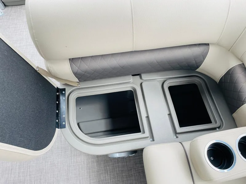 Slide: The Image of 2025 Sun Tracker SportFish 20 DLX boat storage compartment with cup holders. - 23