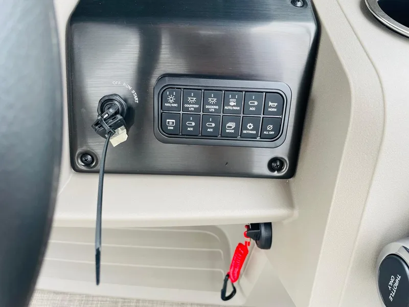Slide: The Image of Control panel of 2025 Sun Tracker SportFish 20 DLX boat with switches and ignition. - 27