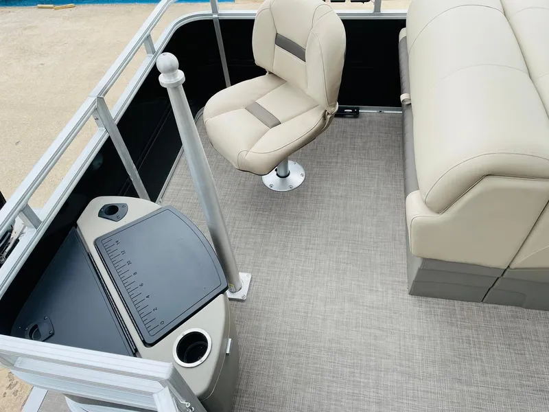 Slide: The Image of 2025 Sun Tracker SportFish 20 DLX interior with beige seating and fishing station. - 29