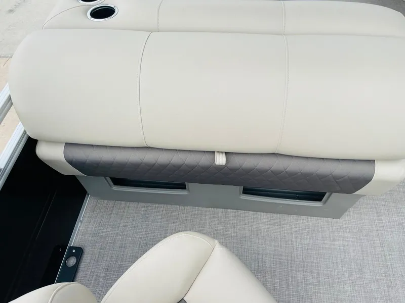 Slide: The Image of Sun Tracker SportFish 20 DLX 2025 boat seating with beige upholstery and cup holder. - 30