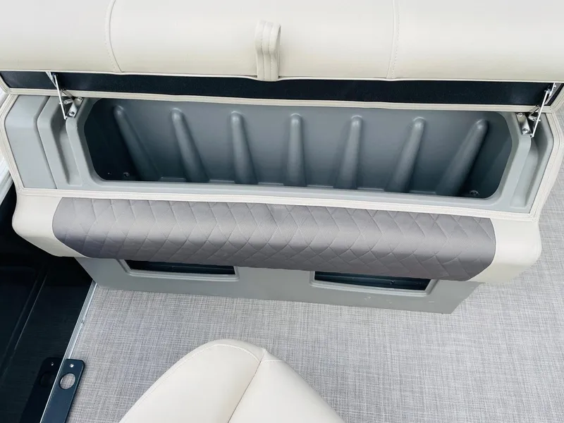Slide: The Image of 2025 Sun Tracker SportFish 20 DLX storage compartment with cushioned seating. - 31