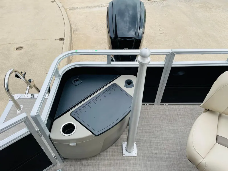 Slide: The Image of 2025 Sun Tracker SportFish 20 DLX boat interior with motor and seating. - 32