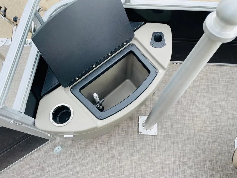 Slide: The Image of 2025 Sun Tracker SportFish 20 DLX boat interior with storage compartment and cup holder. - 33