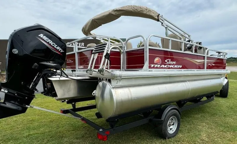 Slide: The Image of 2025 Sun Tracker Bass Buggy 18 DLX pontoon boat with Mercury engine on trailer. - 5
