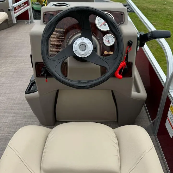 Slide: The Image of 2025 Sun Tracker Bass Buggy 18 DLX steering console with gauges and controls. - 7