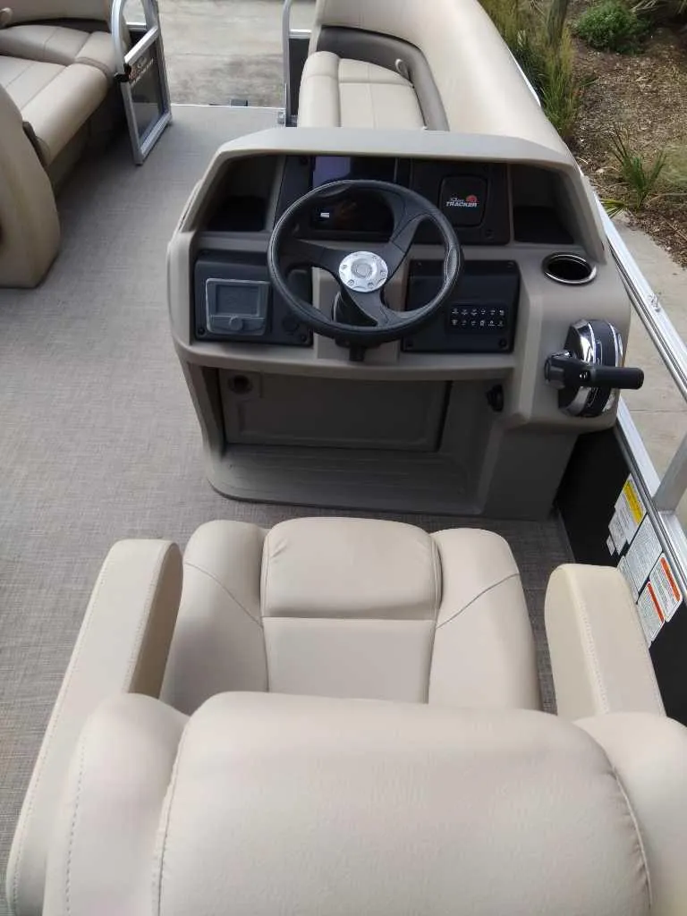 Slide: The Image of 2025 Sun Tracker Party Barge 18 DLX interior with steering console and seating. - 3