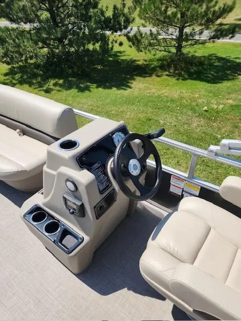 Slide: The Image of 2025 Sun Tracker Party Barge 16 DLX interior with steering console and seating. - 4