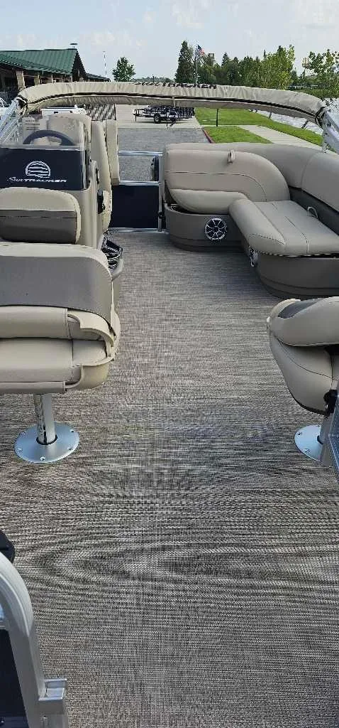 Slide: The Image of 2025 Sun Tracker Bass Buggy 16 XL Select pontoon boat interior with seating and carpeted floor. - 3