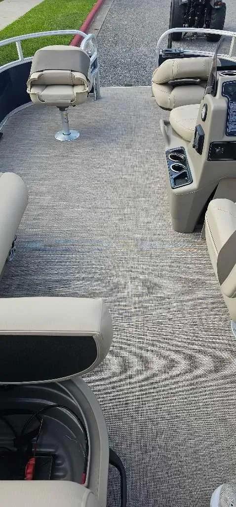 Slide: The Image of 2025 Sun Tracker Bass Buggy 16 XL Select interior with beige seating and carpeted floor. - 4