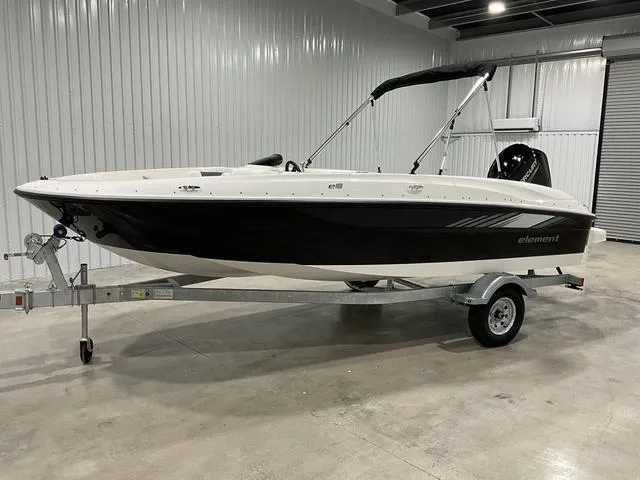 Slide: The Image of 2025 Bayliner Element E18 boat on trailer in indoor storage. - 1