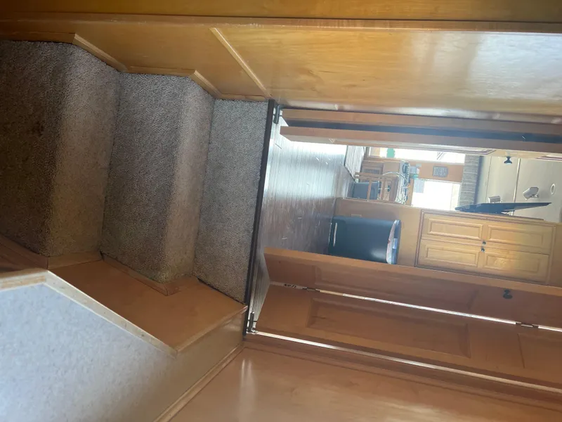 Slide: The Image of Interior view of 2002 Sharpe houseboat with carpeted stairs and wooden cabinetry. - 15