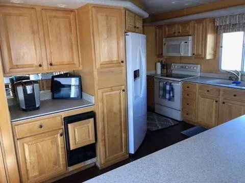 Slide: The Image of Spacious kitchen in 2002 Sharpe houseboat with wooden cabinets and modern appliances. - 2
