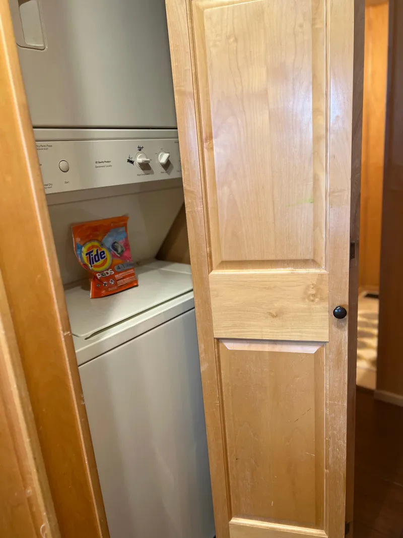 Slide: The Image of Stacked washer and dryer in 2002 Sharpe houseboat with wooden door. - 21