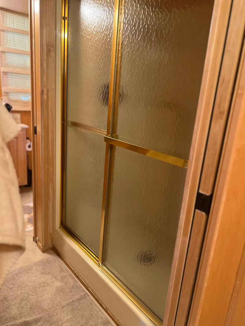 Slide: The Image of Shower door with gold trim in 2002 Sharpe houseboat bathroom. - 26