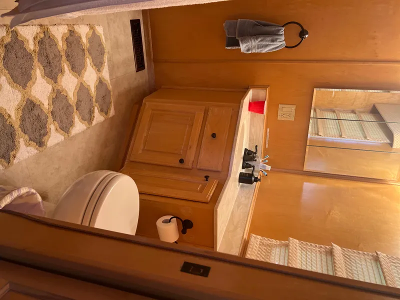 Slide: The Image of Bathroom interior of 2002 Sharpe houseboat with vanity and patterned rug. - 30