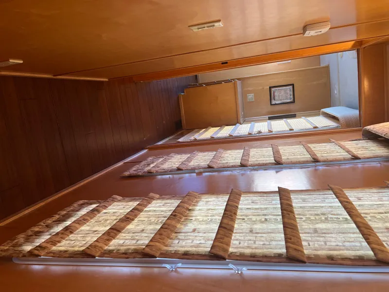 Slide: The Image of Interior of a 2002 Sharpe houseboat with wooden walls and window blinds. - 32