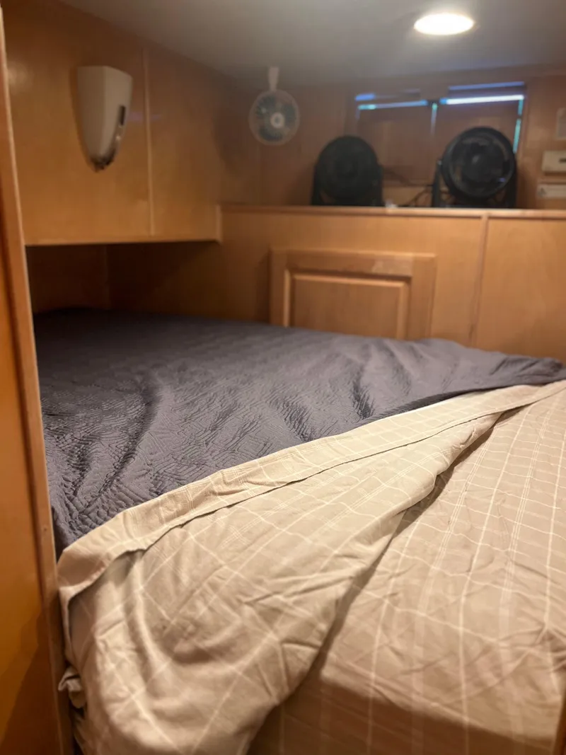 Slide: The Image of Cozy bedroom in a 2002 Sharpe houseboat with wooden paneling and soft lighting. - 33